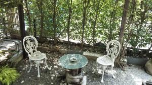 a table and two chairs and a table and a table and chairs at Kyoto Narutaki Keisenso in Kyoto