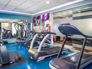 a gym with several treadmills and cardio machines at Mercure Santiago Centro in Santiago
