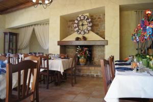 a dining room with tables and a clock on the wall at Agriturismo Mammarella in Altavilla Silentina