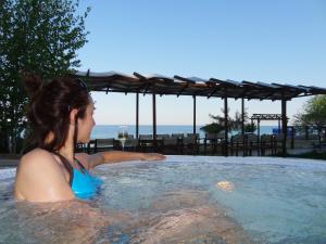 a woman in a jacuzzi in a hot tub at Family Hotel Albizia Beach in Varna City