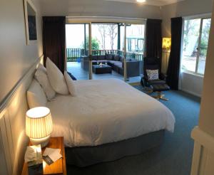 a bedroom with a large bed and a living room at Valley View Luxury Retreat in Vacy