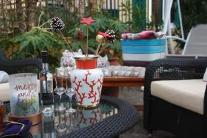 a table with a vase with flowers and wine bottles at Hotel Alba in Lavagna