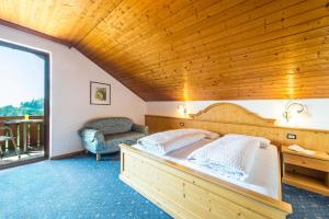 a bedroom with a bed with a wooden ceiling at Gasthof Wieser in Appiano sulla Strada del Vino