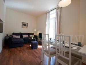 a living room with a couch and a table at Apartamentos Murallas de Sevilla in Seville