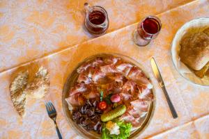 a table with a plate of food on a table at Gasthof Wieser in Appiano sulla Strada del Vino