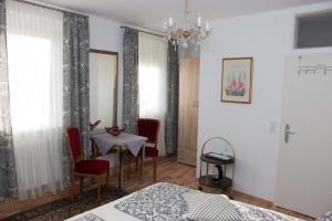 a bedroom with a table and a dining room at Gasthaus zum Adler in Baden-Baden