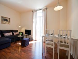 a living room with a couch and a table at Apartamentos Murallas de Sevilla in Seville