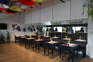 a row of tables and chairs in a restaurant at Hotel Moerser Hof in Moers