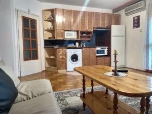 a living room with a table and a kitchen at Martin`s apartments in Stara Zagora