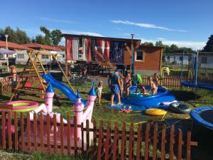 a group of people playing in a playground at Domki Letniskowe u Susła in Sianozety