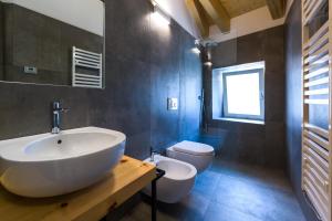 a bathroom with a white sink and a toilet at Casa Kaki in Malcesine +128 photos