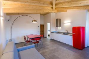 a kitchen with a red refrigerator and a table at Casa Kaki in Malcesine