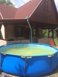 a large hot tub in front of a house at Boglárka Horgásznyaraló in Gyomaendrőd