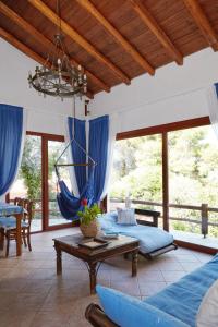 a room with two beds and a hammock at Villa Madag in Koukounaries