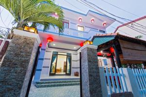 a house with a gate in front of it at Bougain Villeas Homestay in Hoi An