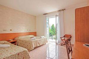 Postel nebo postele na pokoji v ubytování Albergo Rondò