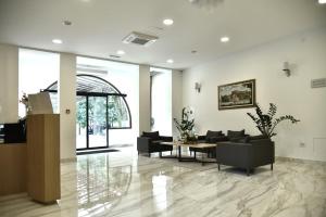 a lobby with couches and a table in a building at Miznah Hotels & Resorts in Bačka Topola