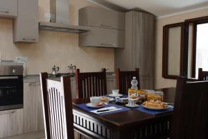 a kitchen with a table with food on it at Ruben holiday in Palinuro