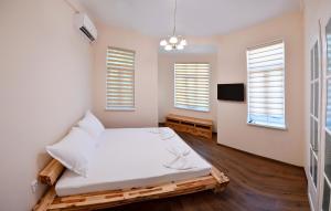 a bedroom with a bed and two windows at Shipka 1 in Varna City +1 photo