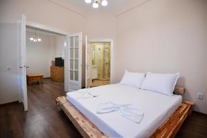 a bedroom with a large white bed with a bow on it at Shipka 1 in Varna City
