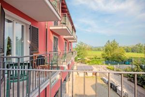 a balcony of a pink house with a view at Albergo Rondò in Acqui Terme