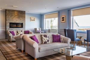 a living room with a couch and a fireplace at Kinloch Hotel, Isle of Arran in Blackwaterfoot