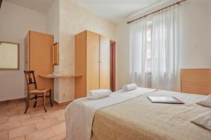 Postel nebo postele na pokoji v ubytování Albergo Rondò
