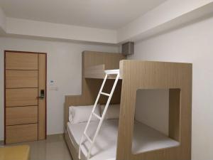 a small bedroom with a bunk bed with a ladder at Roseate Bangkok Hotel in Bangkok +5 photos