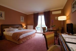 a hotel room with a bed and a window at Domaine De Villers & Spa in Villers-sur-Mer