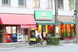 a scooter parked in front of a store at Tokaichi inn 一軒家貸切 in Hiroshima