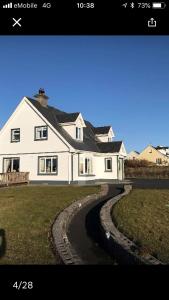 a large white house with a winding road at Lorna's Apartment Self Catering Holiday Home in Miltown Malbay