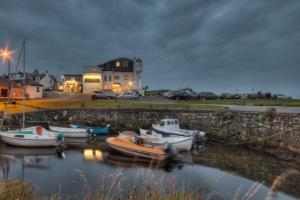 a group of boats are docked in a harbor at Kinloch Hotel, Isle of Arran in Blackwaterfoot