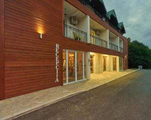 a building with a balcony on the side of it at Hotel Serdar in Mojkovac