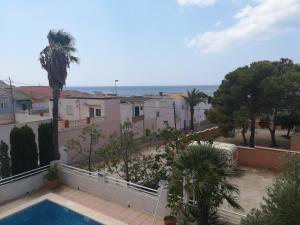 a view from the balcony of a house with a swimming pool at Chalet con dos apartamentos in La Azohía