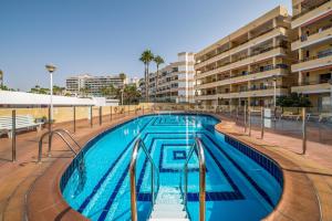 a swimming pool in the middle of a building at Cosy Corner Playa del Inglés in Playa del Ingles