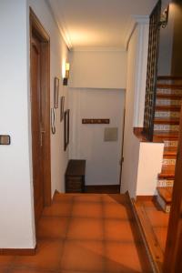 a hallway with a door and a stair case at Casa Santo Tomé in Toledo