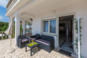 a patio with two chairs and a table at Apartments Slavica in Dramalj