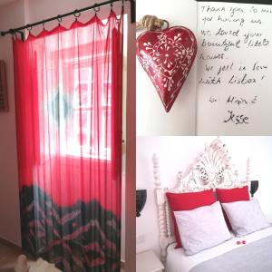 a bedroom with a red curtain and a heart on the wall at Casinhas da Ajuda nº 29 in Lisbon