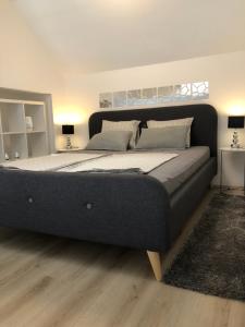 ein großes Bett in einem Schlafzimmer mit zwei Lampen in der Unterkunft Luma 1 in Osijek