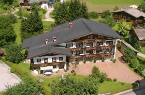 an aerial view of a large house with a black roof at Der Bräuschmied in Lofer