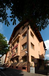 a tall building with a sign on the side of it at Pensiunea Ambient in Braşov