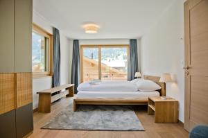 מיטה או מיטות בחדר ב-Chalet Rothenegg - GRIWA RENT AG