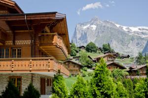 a building with a mountain in the background at Chalet Rothenegg - GRIWA RENT AG in Grindelwald