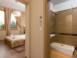 a bathroom with a bed and a shower at Hotel Lirak in Tetovo