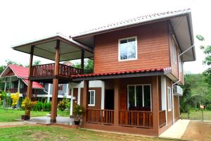 a house with a wrap around porch at Bang Hon Homestay in Ko Yao Noi