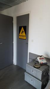 a room with two suitcases and a sign on a wall at Leucateloc in Leucate-Plage