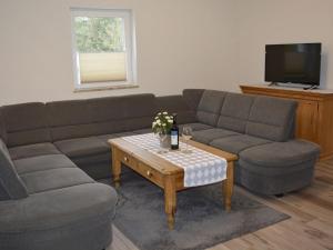 a living room with a couch and a coffee table at Ferienwohnung Teltow 2 in Teltow