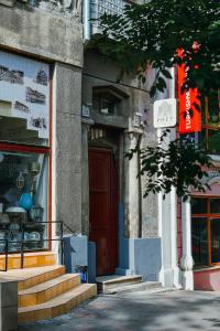 a building with a red door on a street at Poet Art Hotel in Odesa