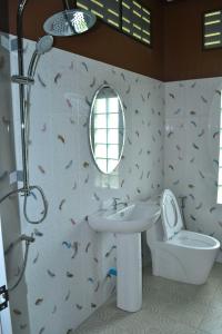 a bathroom with a sink and a toilet and a mirror at Bang Hon Homestay in Ko Yao Noi