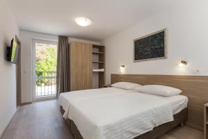 Postel nebo postele na pokoji v ubytování Hotel Vimbula - Komolac